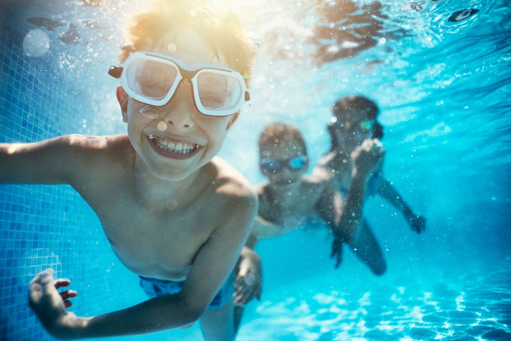 kids swimming under water excited on vacation