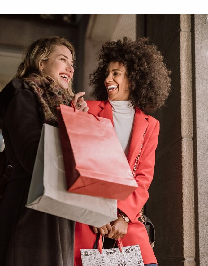 image of two happy women carry many shopping bags